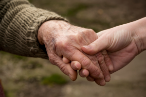 LifeRing Caregivers Meeting image -- Elderly hand held by young hand