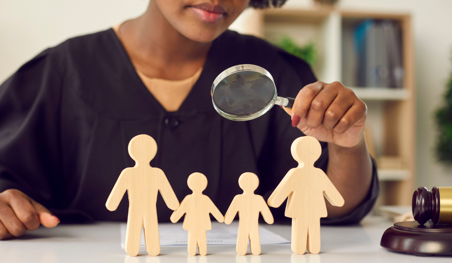Image of judge looking at paperdoll family