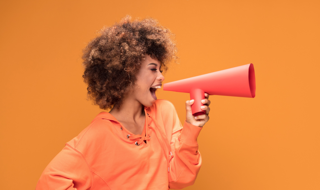 Young woman with megaphone calling all LifeRing Meeting Delegates
