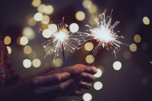 Image of hands holding sparklers to celebrate LifeRing Independence Day